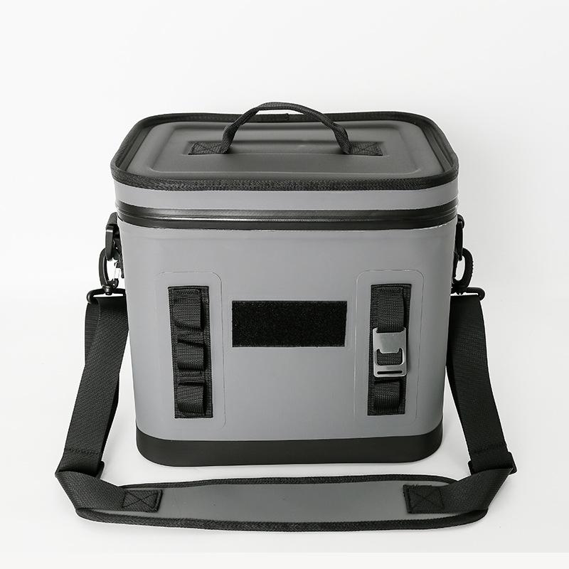 Grey soft cooler showing front buckle straps and branding area