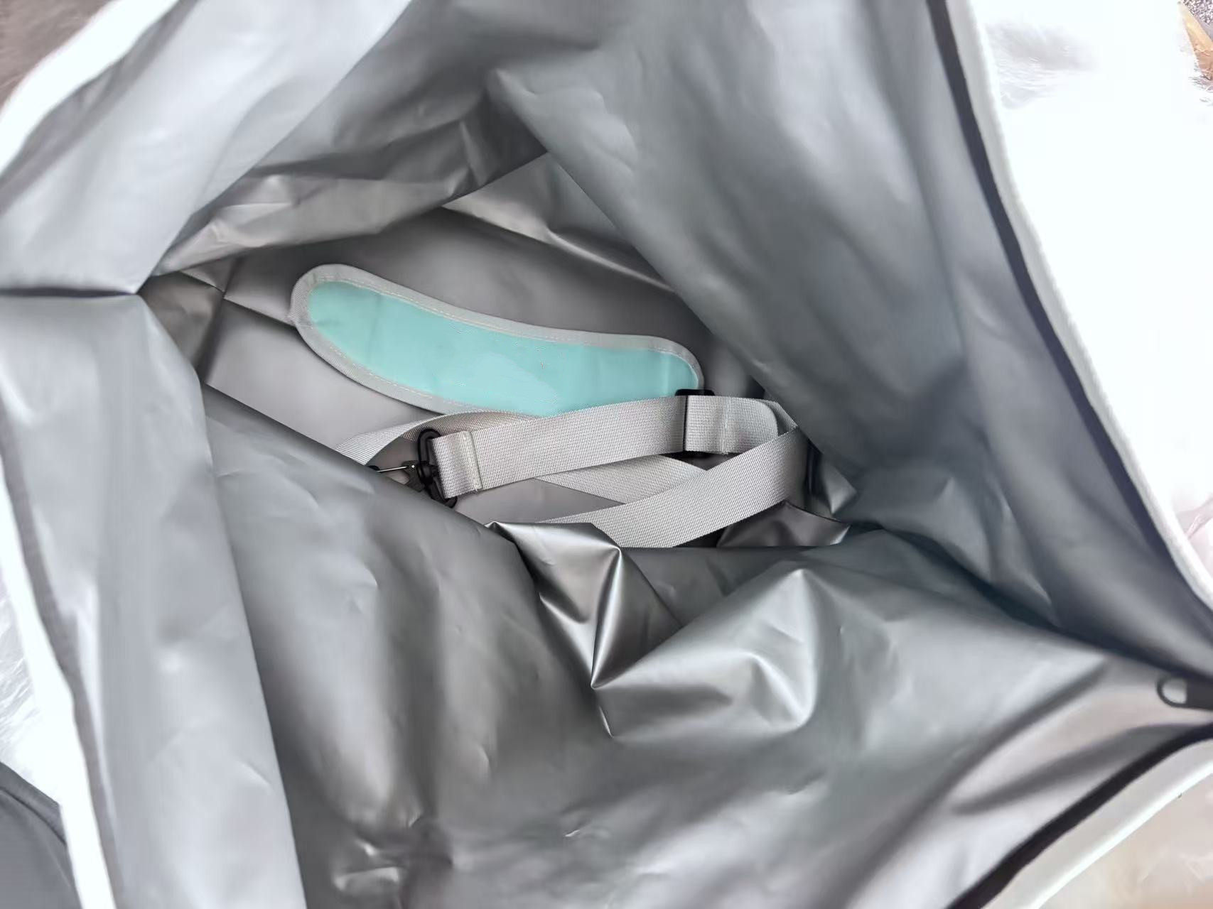 Interior liner and shoulder strap storage of YT102 cooler tote