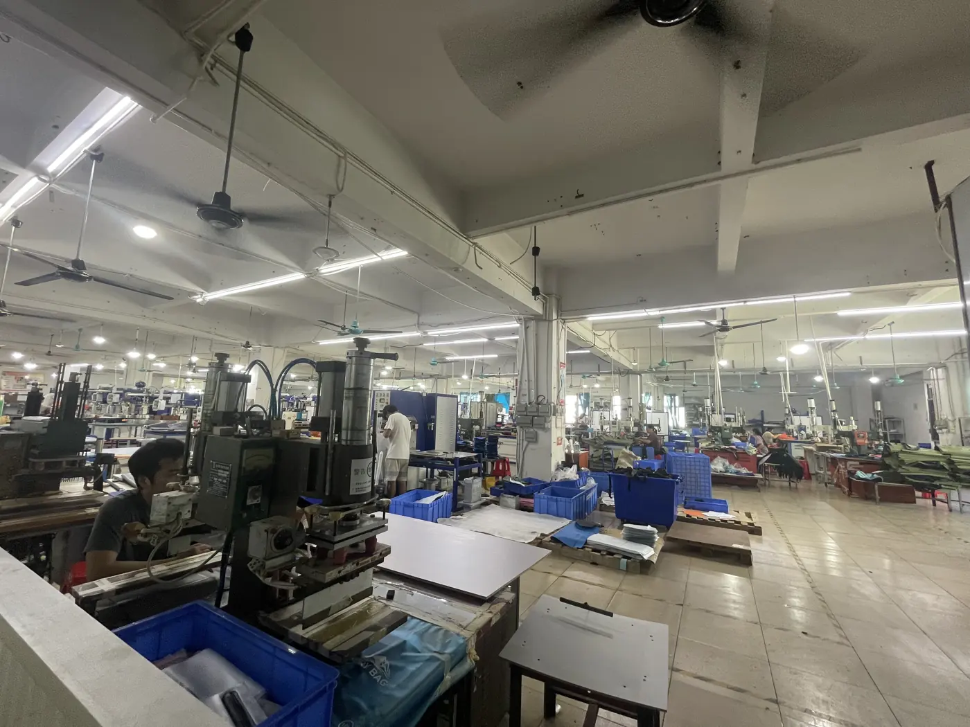 Equipment workstations and in-process materials at the Outdoorsbloom workshop in Dongguan