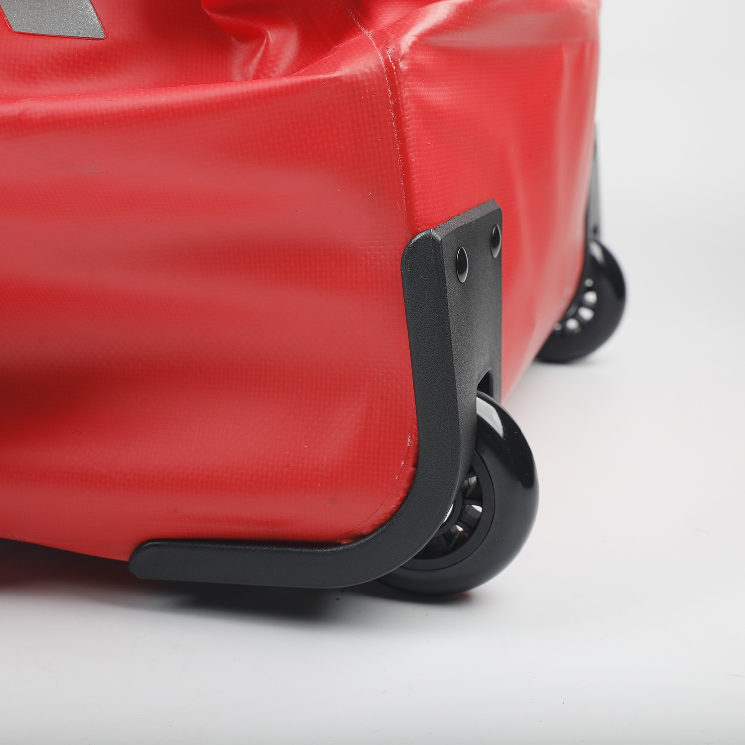 Close-up of duffel wheel and base attachment