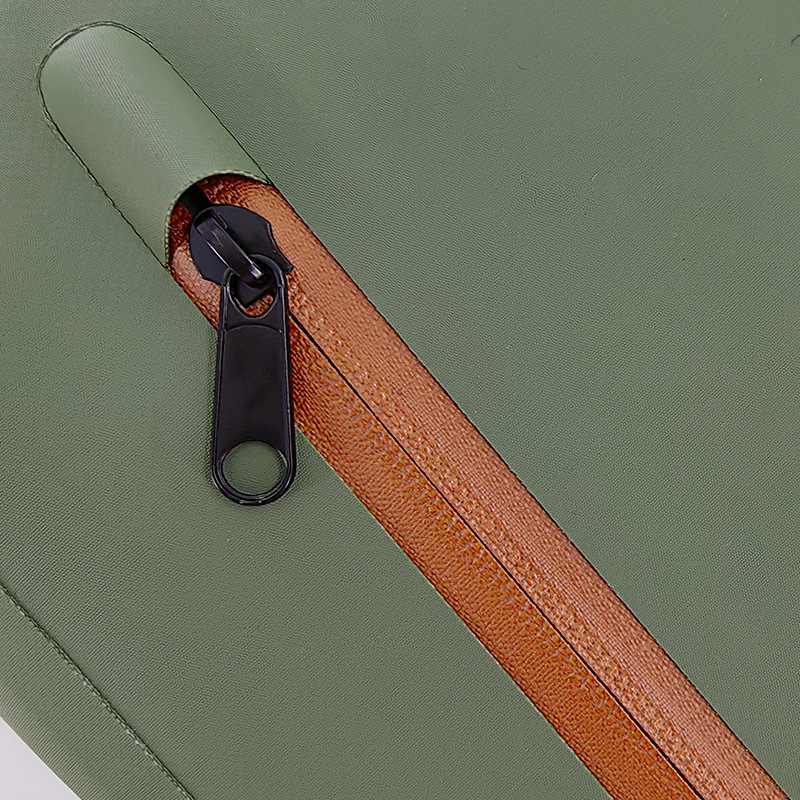 Close-up of front zipper on olive fishing sling