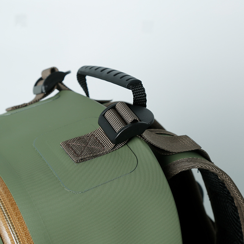 Top carry handle and strap attachment detail on olive waterproof daypack