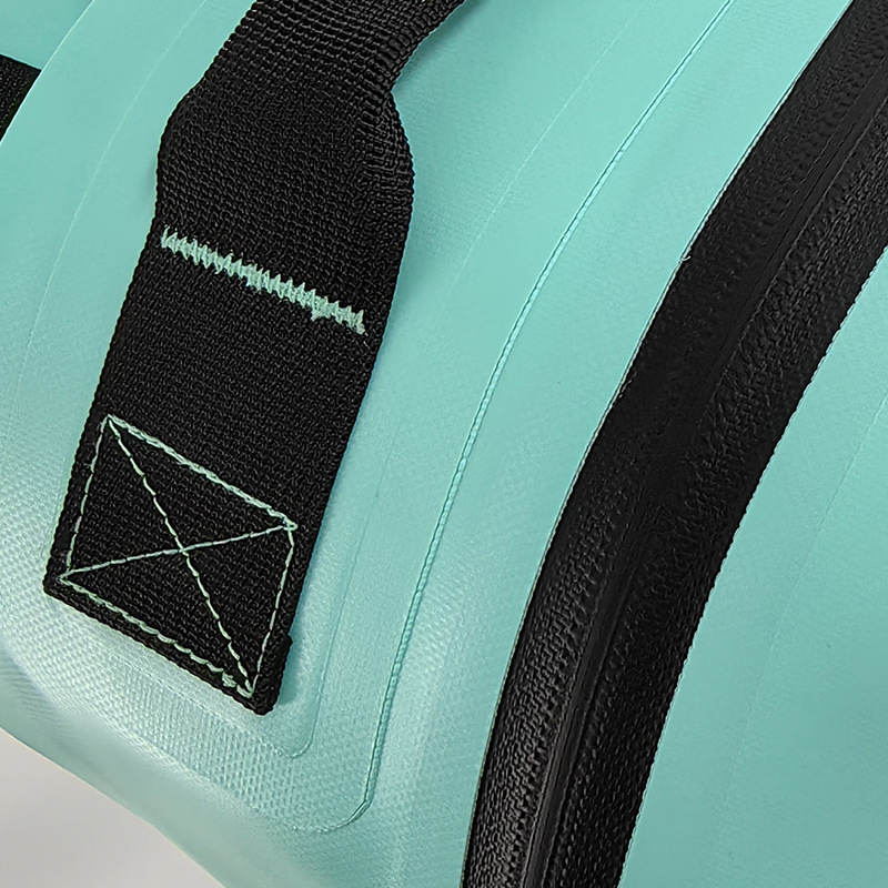 Close-up of welded strap anchor on mint TPU backpack