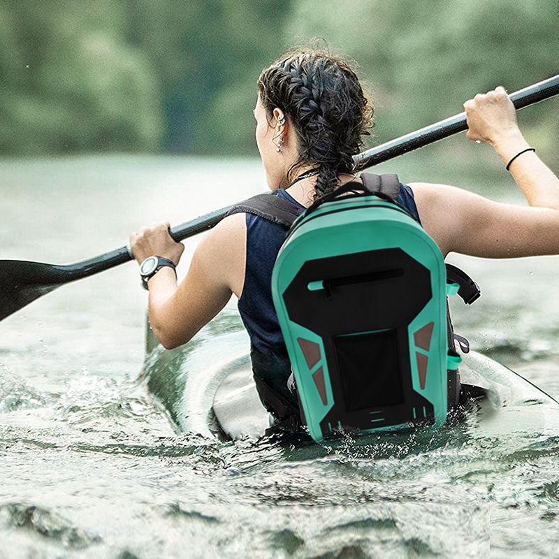 Mint waterproof backpack shown in a paddling setting